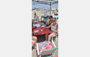 Repas paëlla à la plage sous un grand barnum
